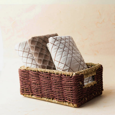 Brown Babui Utility Basket made of Sabaii grass with folded towels inside