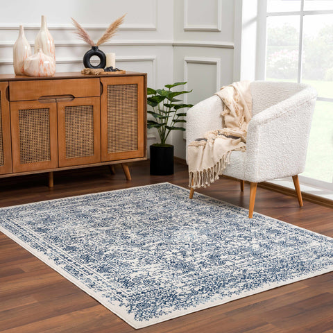 Michie Blue Area Rug with traditional navy and white pattern in modern living room.